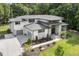 Beautiful home exterior featuring a three-car garage with modern glass doors and professionally landscaped yard at 213 Westhampton Dr, Pittsboro, NC 27312
