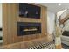 Close-up of a modern fireplace with black marble surround and custom wood paneling at 213 Westhampton Dr, Pittsboro, NC 27312