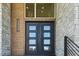Grand entrance features double doors, stone and wood accents and transom window at 213 Westhampton Dr, Pittsboro, NC 27312