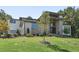 Front exterior showcasing the modern design with stone accents, ample windows, and a well-maintained lawn at 213 Westhampton Dr, Pittsboro, NC 27312
