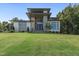 Impressive front exterior with stone detailing, large windows, and a meticulously landscaped front lawn at 213 Westhampton Dr, Pittsboro, NC 27312