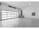 Spacious garage featuring an epoxy floor, transparent glass door, and ample lighting for versatile use at 213 Westhampton Dr, Pittsboro, NC 27312
