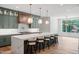Bright, modern kitchen featuring a large island with seating and marble countertops at 213 Westhampton Dr, Pittsboro, NC 27312