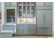 Contemporary kitchen with modern appliances, a built-in wine cooler, and elegant cabinetry with stylish brass hardware at 213 Westhampton Dr, Pittsboro, NC 27312