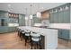 Well-lit modern kitchen with marble island and seating offering a stylish dining space at 213 Westhampton Dr, Pittsboro, NC 27312