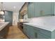 Gourmet kitchen featuring a Wolf range, sleek countertops, pot filler, and custom cabinets with gold hardware at 213 Westhampton Dr, Pittsboro, NC 27312