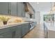 Gourmet kitchen featuring a Wolf range, sleek countertops, pot filler, and custom cabinets with gold hardware at 213 Westhampton Dr, Pittsboro, NC 27312