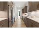Galley kitchen with stainless steel appliances, sleek countertops, and modern cabinetry at 213 Westhampton Dr, Pittsboro, NC 27312