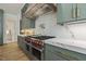 Gourmet kitchen featuring a pro-grade range, custom cabinets, and a pot filler faucet at 213 Westhampton Dr, Pittsboro, NC 27312