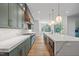 Modern kitchen with marble countertop and cabinets in natural light from the window at 213 Westhampton Dr, Pittsboro, NC 27312