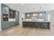 The kitchen features a large central island with seating, marble countertops, stylish pendant lighting and modern appliances at 213 Westhampton Dr, Pittsboro, NC 27312