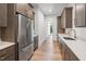 Kitchen with stainless steel appliances, custom cabinets, and eat in bar at 213 Westhampton Dr, Pittsboro, NC 27312
