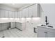 Laundry room with patterned tile floors, white cabinets and quartz countertops at 213 Westhampton Dr, Pittsboro, NC 27312