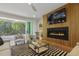 Living room features modern fireplace, neutral furnishings, and open views to the backyard and patio area at 213 Westhampton Dr, Pittsboro, NC 27312