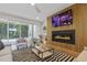 Living room features fireplace, modern decor, neutral furnishings, and open views to the backyard at 213 Westhampton Dr, Pittsboro, NC 27312
