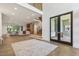 Open living room with hardwood floors, modern fireplace, and stairs to the second floor at 213 Westhampton Dr, Pittsboro, NC 27312
