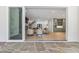 Spacious living room with modern fireplace, stairs, and open floorplan, viewed from stone patio with expansive sliding glass doors at 213 Westhampton Dr, Pittsboro, NC 27312