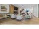 Cozy living room with a fireplace, hardwood floors, and a view of the modern staircase at 213 Westhampton Dr, Pittsboro, NC 27312