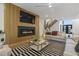 Bright and airy living room showcasing a fireplace, modern staircase, and stylish furnishings at 213 Westhampton Dr, Pittsboro, NC 27312
