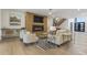 Open-concept living room with a modern fireplace, hardwood floors, and comfortable seating arrangement at 213 Westhampton Dr, Pittsboro, NC 27312