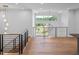 Open loft featuring modern lighting, railings, and natural light from the large picturesque windows at 213 Westhampton Dr, Pittsboro, NC 27312