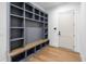 Mudroom with custom gray built-in cabinet and bench by the door at 213 Westhampton Dr, Pittsboro, NC 27312