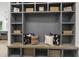 Close up on a mudroom nook featuring custom shelves, stylish pillows, and woven storage baskets at 213 Westhampton Dr, Pittsboro, NC 27312