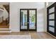 Home office with a glass desk, modern light fixture, and view of a wooded lot at 213 Westhampton Dr, Pittsboro, NC 27312