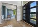 Home office features a glass desk, modern chandelier, and a large window overlooking nature at 213 Westhampton Dr, Pittsboro, NC 27312