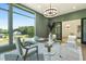 Bright office with glass desk and views of landscaped neighborhood through the glass doors at 213 Westhampton Dr, Pittsboro, NC 27312