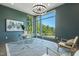 Bright office features large windows with natural light, glass desk, stylish chandelier, and neutral decor at 213 Westhampton Dr, Pittsboro, NC 27312