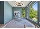 Office features a glass desk, stylish light fixture, and large window with treelined views at 213 Westhampton Dr, Pittsboro, NC 27312