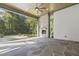 Covered patio with stone flooring, a fireplace, and a view of the surrounding trees at 213 Westhampton Dr, Pittsboro, NC 27312