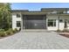 Modern patio featuring stone pavers, exterior lighting, and access to a screened-in porch for outdoor entertaining at 213 Westhampton Dr, Pittsboro, NC 27312