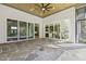 The covered patio features a wooden ceiling and multiple glass sliding doors offering serene views and an inviting outdoor living space at 213 Westhampton Dr, Pittsboro, NC 27312