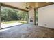 Inviting patio with stone fireplace and expansive backyard view with a ceiling fan at 213 Westhampton Dr, Pittsboro, NC 27312