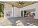 Covered patio with a stone fireplace, stone flooring, and a peek into the home's interior at 213 Westhampton Dr, Pittsboro, NC 27312
