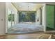 Covered patio with a stone fireplace, large sliding doors, and a view of the wooded backyard at 213 Westhampton Dr, Pittsboro, NC 27312