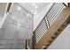 Modern staircase with a black metal railing, wooden steps, and gray accent wall with white trim at 213 Westhampton Dr, Pittsboro, NC 27312