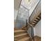 Staircase with natural wood steps, dark railings, and decorative gray wall panels at 213 Westhampton Dr, Pittsboro, NC 27312
