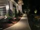 Well-lit walkway with beautiful landscaping leading to a modern home, providing curb appeal at 213 Westhampton Dr, Pittsboro, NC 27312