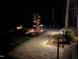 Tranquil walkway and garden area with a decorative tree and landscaping at nighttime at 213 Westhampton Dr, Pittsboro, NC 27312