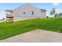 Home's back exterior shows small deck, freshly seeded lawn and patio area at 164 Clove Hitch Ln, Fuquay Varina, NC 27526