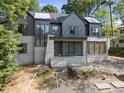 New construction modern home featuring a stone facade, dark siding, and large windows at 508 Northwood Dr, Raleigh, NC 27609