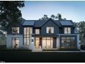 Beautifully landscaped home with modern design featuring large windows and a stone and siding exterior at 508 Northwood Dr, Raleigh, NC 27609