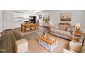Bright living room showcasing an open layout with hardwood floors, neutral furniture, and an eat-in kitchen with stainless steel appliances at 130 S Estes Dr # B7, Chapel Hill, NC 27514