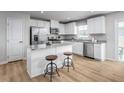 Bright kitchen with stainless steel appliances, a center island, and ample cabinet space for storage at 356 N Coral Bells Way Way, Four Oaks, NC 27524