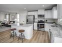 Modern kitchen featuring stainless steel appliances and island with seating at 356 N Coral Bells Way Way, Four Oaks, NC 27524