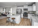 Modern kitchen featuring stainless steel appliances, granite countertops, and a breakfast bar with seating at 356 N Coral Bells Way Way, Four Oaks, NC 27524