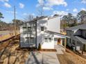 Contemporary home with gray siding, an orange front door, and neatly landscaped yard at 100 Farris Ct, Raleigh, NC 27610